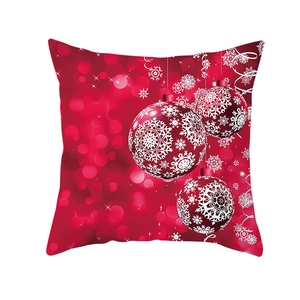Macro detail of red Christmas pillowcase featuring festive baubles and snowflake motifs