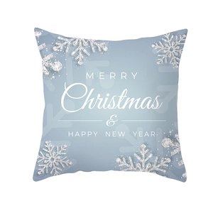 Detail of blue gradient Christmas pillow cover with snowflake patterns and festive lettering