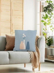 Detailed close-up of light blue Nordic throw pillow with geometric vase prints on sofa