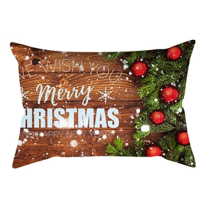 Detail of Christmas lumbar pillowcase with wood grain pattern and festive pine branches