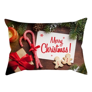 Macro detail of Christmas lumbar pillow cover featuring festive pine, gifts, and candles
