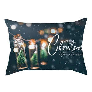 Macro shot of rectangular Christmas pillowcase featuring printed trees and warm lights