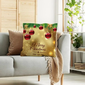 Federa natalizia dorata con palline rosse e stelle su un divano grigio