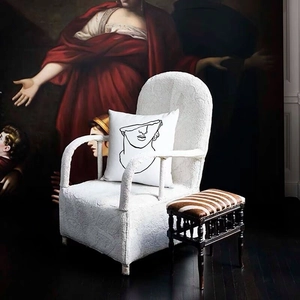 Modern linen pillowcase with black line art sculpture print on a white armchair