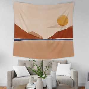 Detailed close-up of a minimalist sunset mountain tapestry hanging above a grey sofa