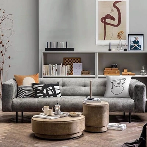 Abstract geometric linen cushion covers on a modern grey fabric sofa in a cozy living room