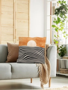 Detail view of abstract geometric pillow cover on a gray sofa with Nordic home decor