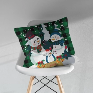 Close-up of a Christmas snowman family on a green and black buffalo plaid pillow cover