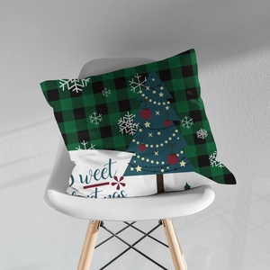 Green and black buffalo plaid Christmas pillow cover with Sweet Christmas print on a chair
