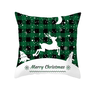 Detail of Christmas pillowcase with green buffalo plaid, reindeer, and snowman motifs