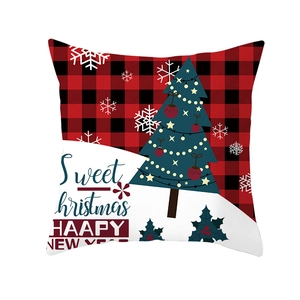 Detail of Christmas tree print on red and black buffalo plaid festive pillow cover