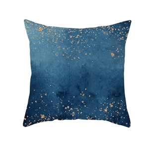 Close-up of blue watercolor ink cushion cover with gold foil accents on the edges