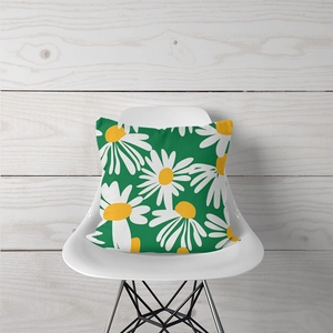Green daisy print square throw pillow cover on a white chair with wooden wall
