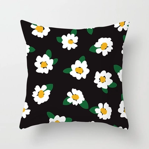 Detailed view of the fine-textured fabric on this black floral daisy pillow cover