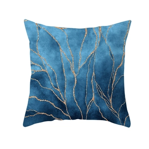 Detail of blue ink abstract cushion cover with golden metallic marble patterns