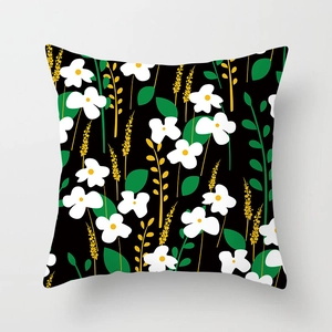 Detailed close-up of a floral daisy pattern on a black square throw pillow cover