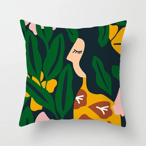 Detailed close-up of a decorative cushion cover with artistic female portrait and floral design