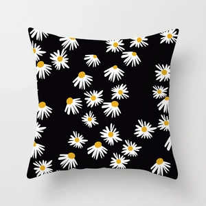 Detailed close-up of daisy pattern on black decorative linen throw pillow cover