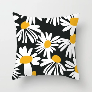 Detailed close-up of a square daisy floral pillowcase with bold black and yellow patterns