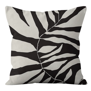 Detail of Nordic decorative pillow cover with abstract tropical leaves in black and white