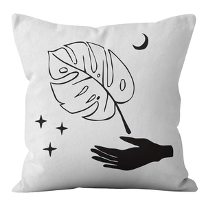 Detail of Nordic boho cushion cover showing black line art of monstera and moon on white fabric