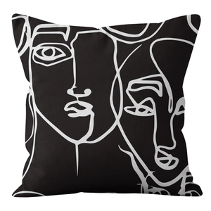 Detail of square pillowcase featuring abstract line art face in black and white tones