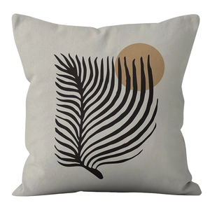 Detail of Nordic cushion cover featuring abstract black leaves and brown sun pattern