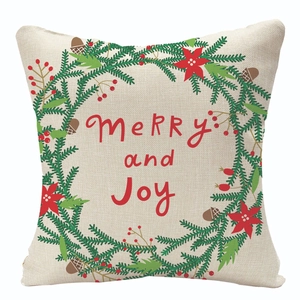 Christmas wreath linen pillow cover with Merry and Joy script on a white background