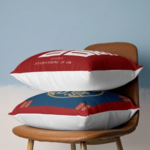 Detail of red and white Chinese New Year cushion covers on a brown leather chair