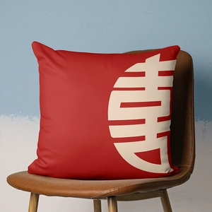 Detail of red festive cushion cover with white Chinese longevity character on a leather chair