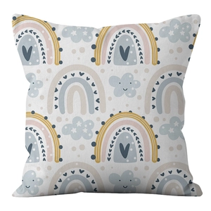 Detailed close-up of rainbow and cloud prints on peach skin fabric cushion cover