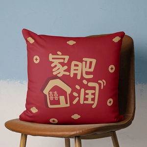 Detail of red festive pillowcase featuring golden Chinese calligraphy on a leather chair