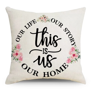 Detail of linen pillow cover with floral patterns and Home story text on white background