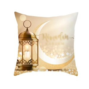 Detail of Ramadan Kareem cushion cover with golden lantern and moon on peach skin fabric