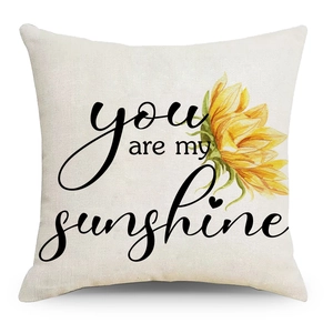 Close-up of linen pillowcase fabric texture with sunflower and you are my sunshine print