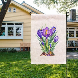 Linen Easter garden flag featuring purple crocus flowers on a black metal stand outdoor