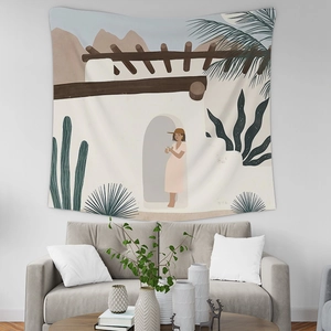 Detail of Nordic minimalist tapestry with abstract desert scene over a grey sofa
