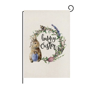 Close-up of Easter garden flag with watercolor rabbit, floral wreath and black metal stand