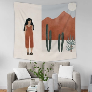 Detail of bohemian tapestry featuring an illustrated woman and desert landscape decor