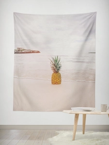Detail of summer beach tapestry with pineapple print hanging on white bedroom wall