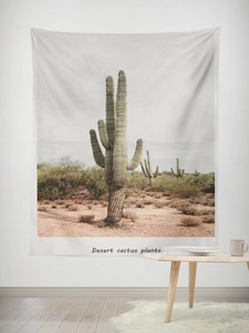 Detail of desert cactus landscape tapestry hanging on a white wall in a minimalist room
