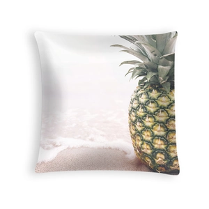 Detail of tropical pineapple and beach wave print on soft peach skin fabric cushion cover