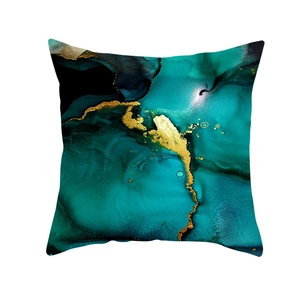 Macro shot of abstract blue and gold marble ink print on square throw pillowcase