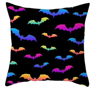 Close-up of colorful gradient bat prints on a black Halloween decorative pillowcase