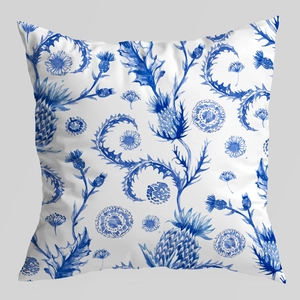 Detailed view of blue and white watercolor thistle pattern on soft velvet cushion cover