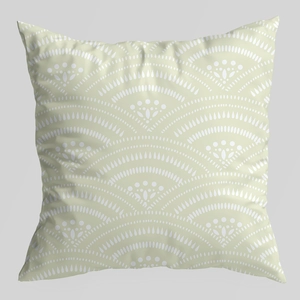 Detail of light green pillow cover featuring white geometric fan patterns and textured fabric