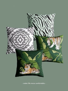 Detail of four tropical tiger pillow covers with green leaf patterns and hidden zippers