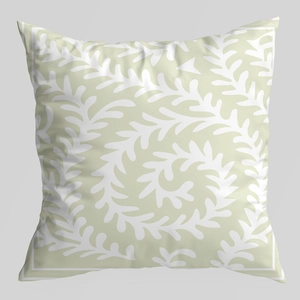 Detail of green cushion cover featuring a white spiral leaf pattern and fine line border