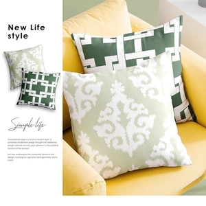 French floral and green geometric throw pillow covers set on a bright yellow sofa