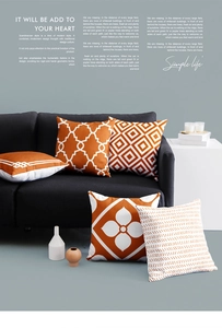 Detail of five luxury orange and white geometric pattern pillow covers on a dark sofa